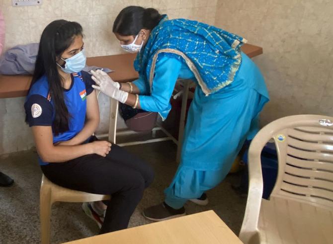 India's Olympics-bound shooter Manu Bhaker is administered the Covishield vaccine at the Community Health Centre (CHC) in Dhakla village, Jhajjar, Haryana.