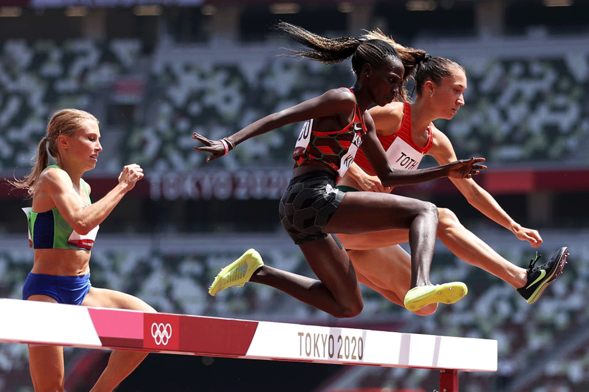 Kenya's Hyvin Kiyeng and Hungary's Lili Anna Toth compete in round one of the Women's 3000m Steeplechase heats of the Tokyo 2020 Olympic Games at Olympic Stadium in Tokyo, on Sunday