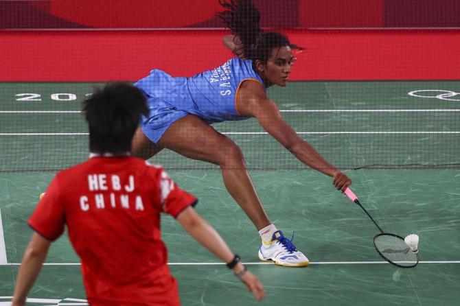 Pusarla Sindhu stretches to return against He Bingjiao.