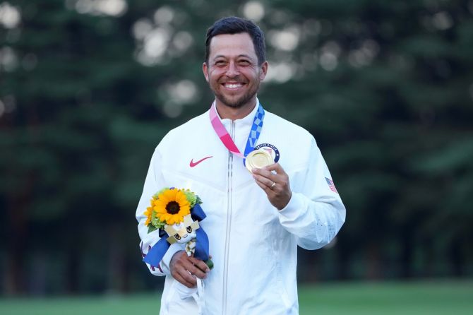 Gold winner Xander Schauffele of the United States, displays his medal after the medal ceremony of the Olympics men's individual stroke play golf event, at Kasumigaseki Country Club, Tokyo, on Sunday