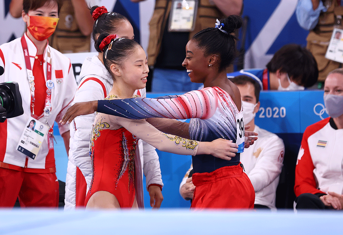 USA's Simone Biles congratulates China's Guan Chenchen