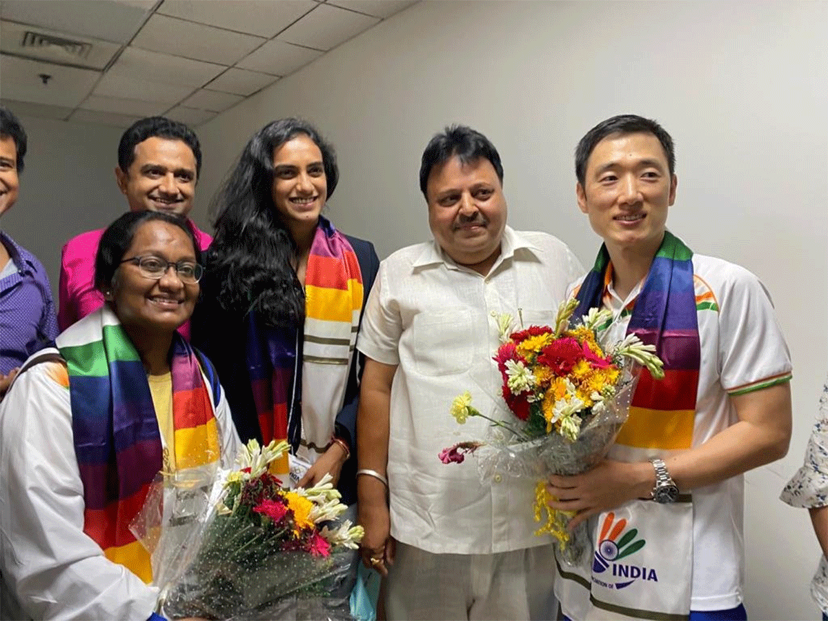 Tokyo Olympic bronze medallist PV Sindhu and her coach Park Tae-Sang welcomed by the general secretary of Badminton Association of India, Ajay Singhania, in Delhi, on Tuesday