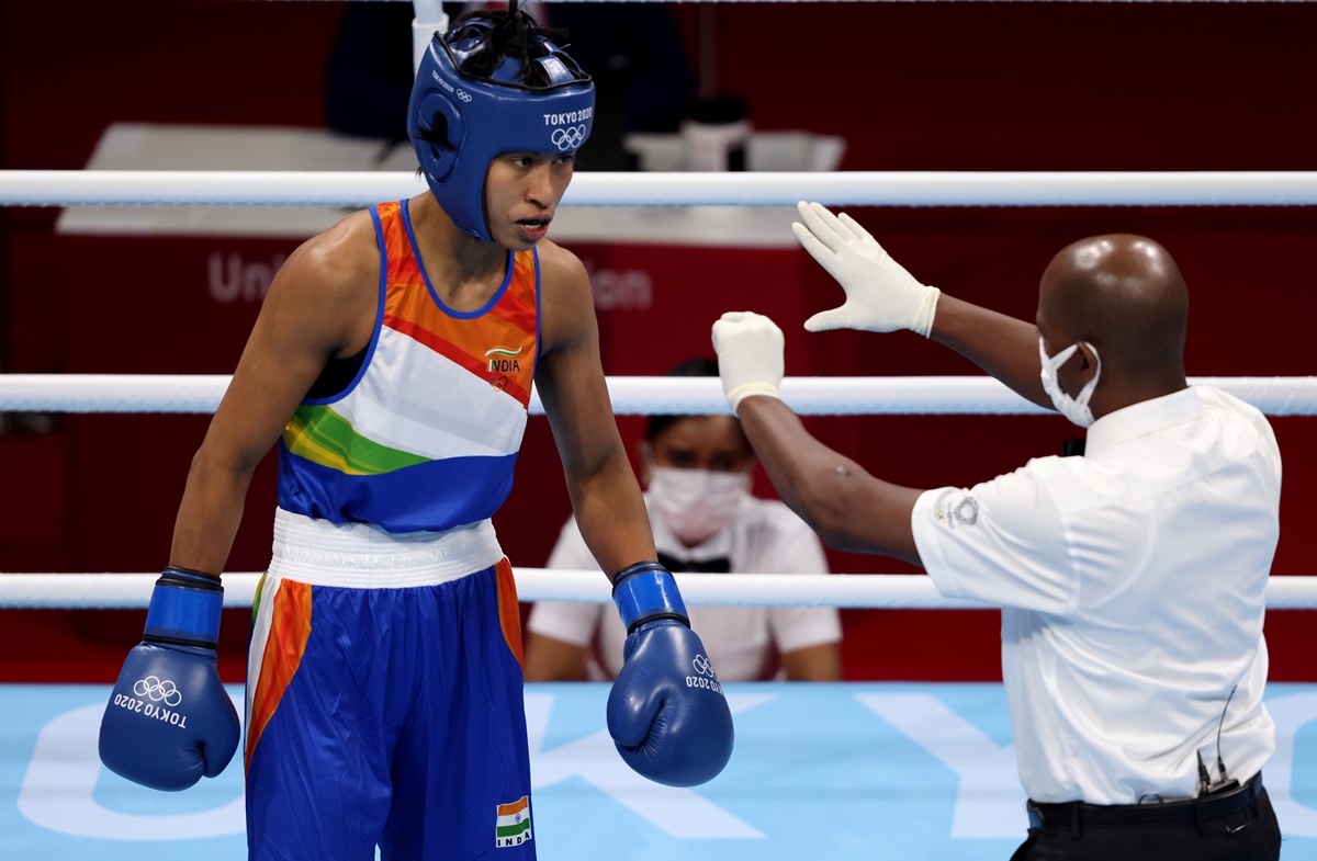 Referee Wilfredo Vazquez Calero of Cuba gives India's Lovlina Borgohain a standing count during the Olympics women's Welterweight (64-69kg) semi-final Turkey's Busenaz Surmeneli.  