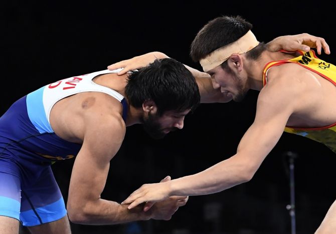 India's Ravi Kumar Dahiya and Kazakhstan's Nurislam Sanayev in action during their Olympics men's 57kg Freestyle semi-final bout, in Tokyo, on Wednesday. 