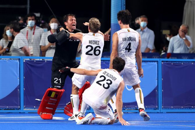 Belgium's goalkeeper Vincent Vanasch is congratulated by teammates Victor Nicky B Wegnez, Arthur Van Doren and Arthur Thierry de Sloover after a superb show in the penalty shoot-out  in the Olympics men's hockey gold medal against Australia on Thursday