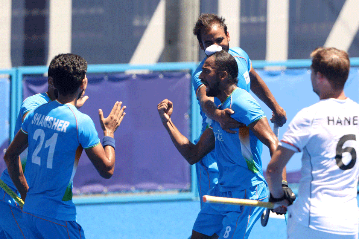 India's Hardik Singh celebrates with teammates on scoring their second goal during the Men's Bronze medal match against Germany during the Tokyo 2020 Olympic Games at Oi Hockey Stadium in Tokyo, on Thursday