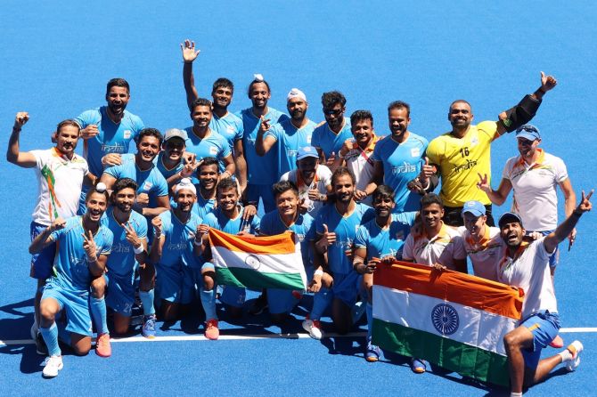 India's players and coach Graham Reid pose for a picture after winning the Olympics men's hockey bronze medal.