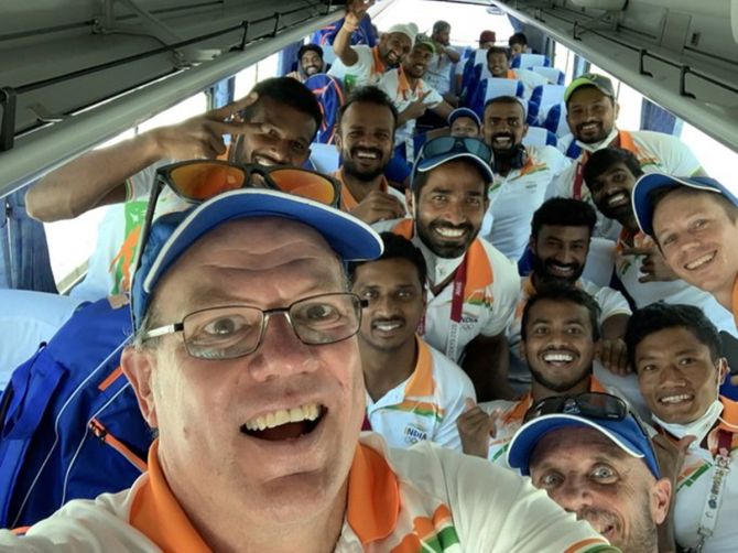 India's men's hockey team coach celebrates with his players on the bus after winning bronze at the Tokyo Olympics on Thursday. 