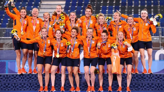 The Netherlands gold medal-winning team poses for photos after the Olympics women's hockey medal ceremony, at Oi Hockey Stadium, in Tokyo, on Friday.