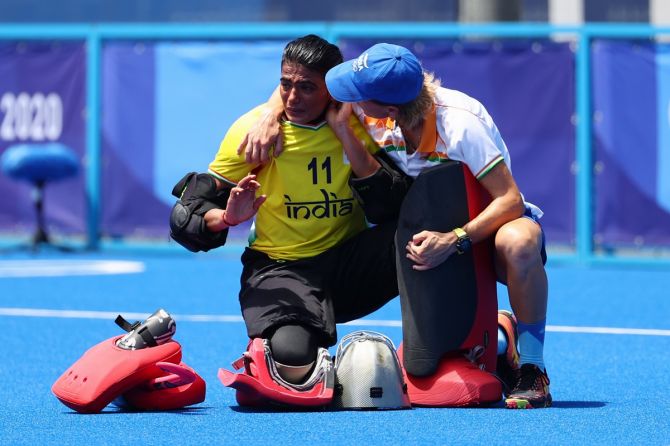 India's goalkeeper Savita Punia, who had a fine match, is consoled by one of the team's support staff after the defeat.