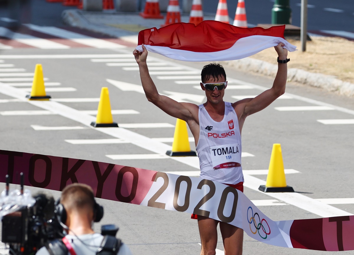Poland's Dawid Tomala crosses the finish line first in the Olympics men's 50km Walk, at Sapporo Odori Park, Sapporo, Japan, on Friday.