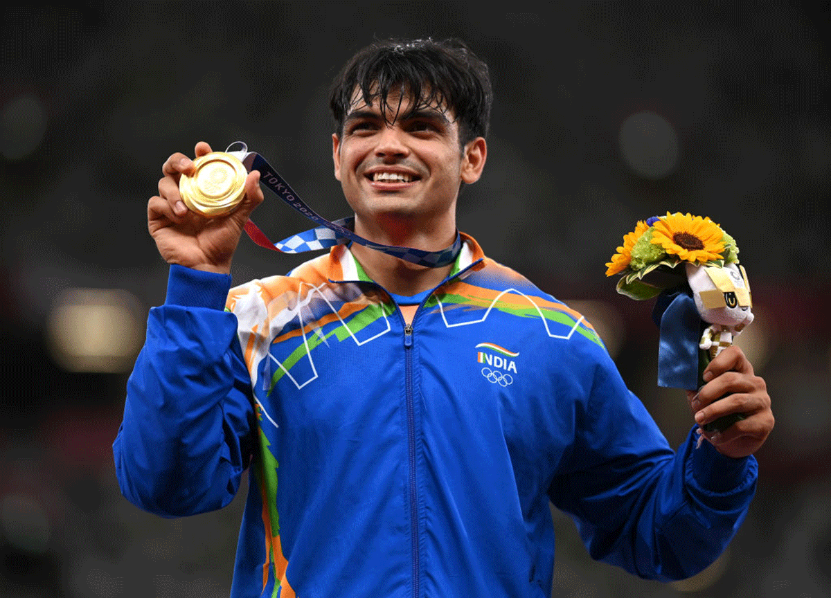 India's gold medallist celebrates on the podium after winning the javelin throw final