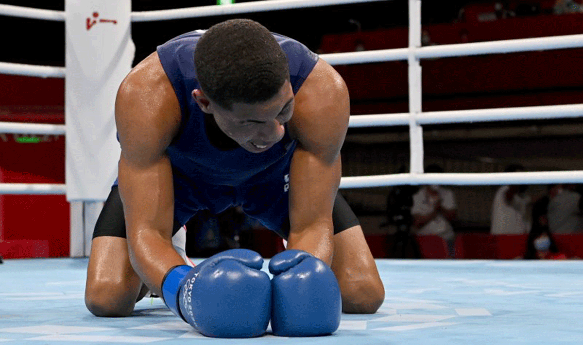 Hebert Sousa of Brazil reacts after knocking down Oleksandr Khyzhniak of Ukraine