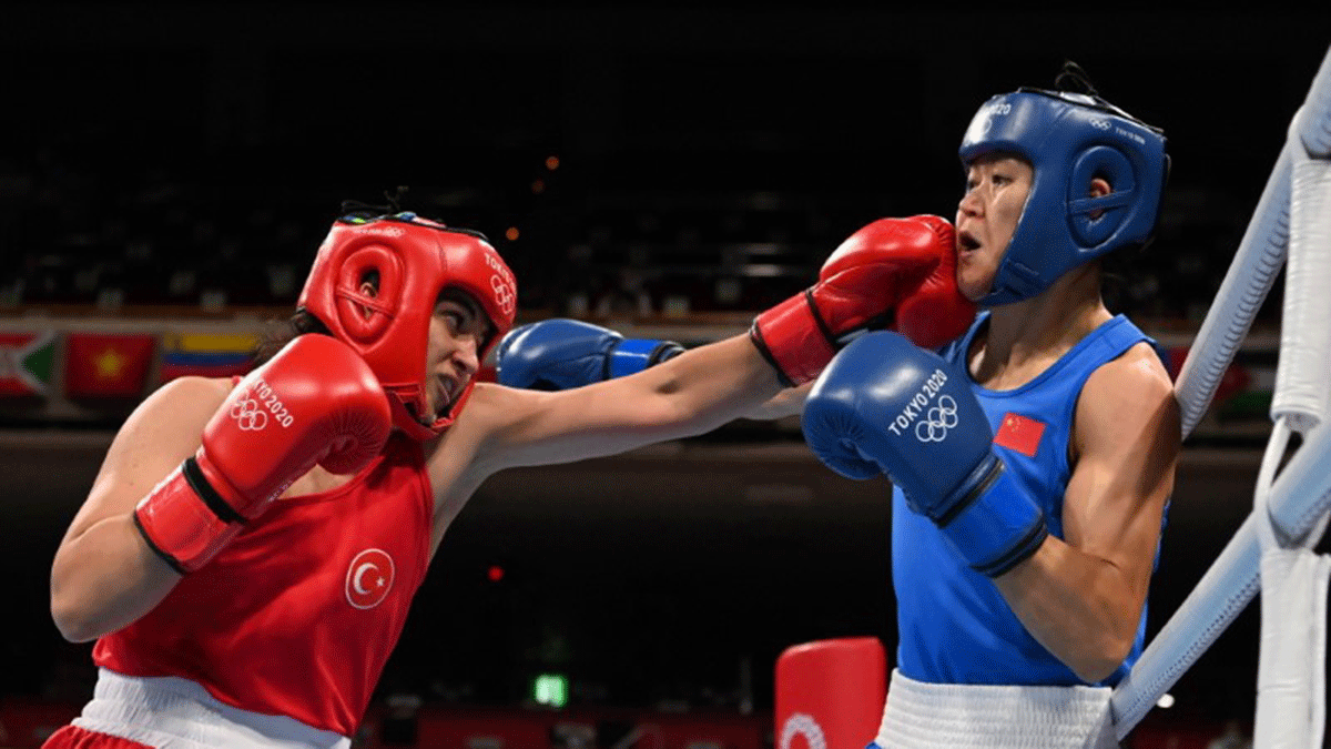Turkey's Busenaz Surmeneli lands a punch on China's Gu Hong during the women's welterweight boxing final at Kokugikan Arena in Tokyo, on Saturday