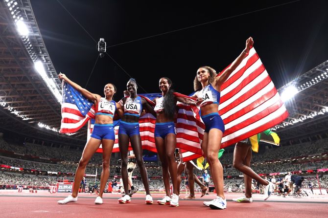 (L-R) Allyson Felix, Athing Mu, Dalilah Muhammad and Sydney McLaughlin of the United States celebrate winning the gold medal in the women's 4 x 400m Relay final.