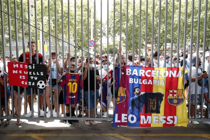 Barcelona fans wait outside the Camp Nou during the press conference. 