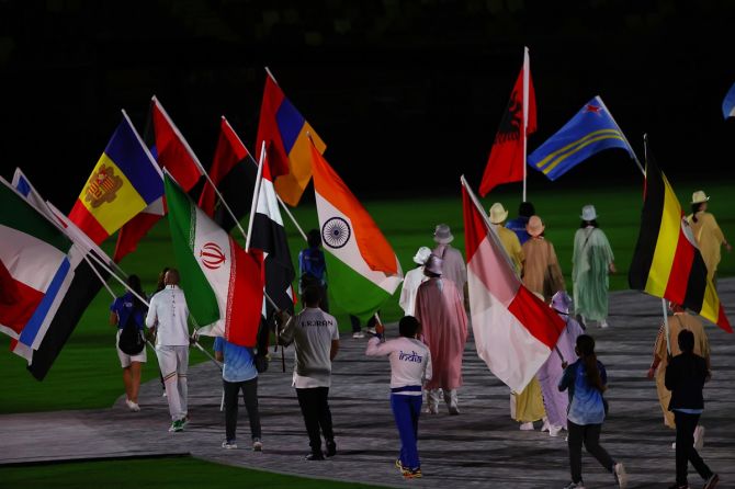 Wrestler Bajrang Punia, who won a bronze, carries the tri-colour as flag-bearers walk into Olympic Stadium for the Games closing ceremony.