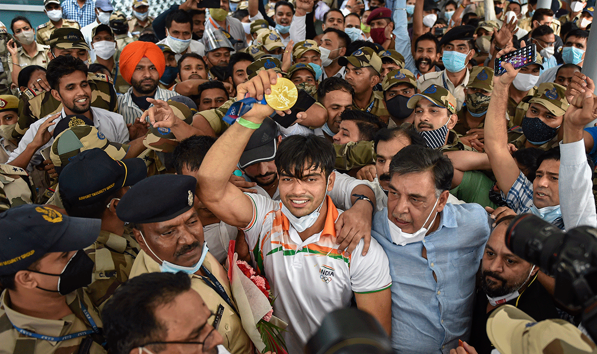 Tokyp Olympics gold medallist Neeraj Chopra receives a raucous welcome at IGI Airport, on his arrival from Tokyo, on Monday