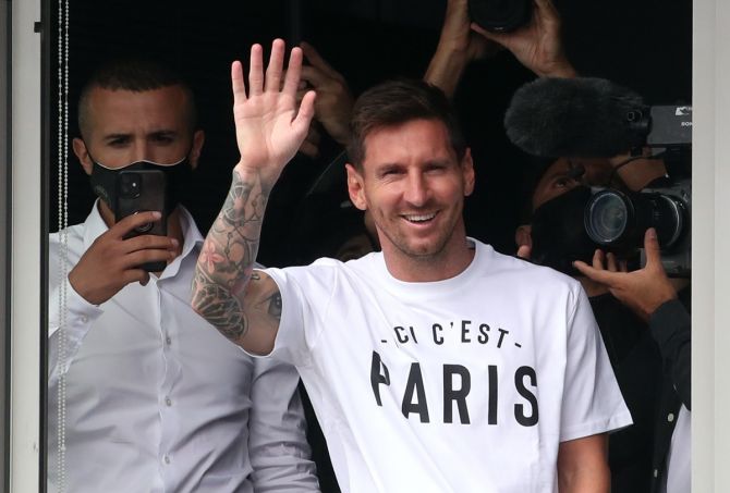 Lionel Messi waves to his fans on arrival at Paris-Le Bourget airport to join Paris St Germain, on Tuesday.