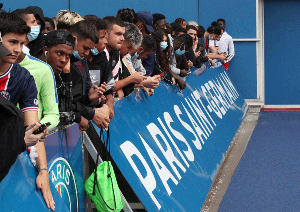 Fans await the arrival of Lionel Messi outside the Parc des Princes before his expected signing for Paris St Germain on Monday 