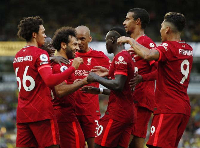 Mohamed Salah celebrates with teammates after scoring Liverpool's third goal against Norwich City, at Carrow Road, Norwich. 