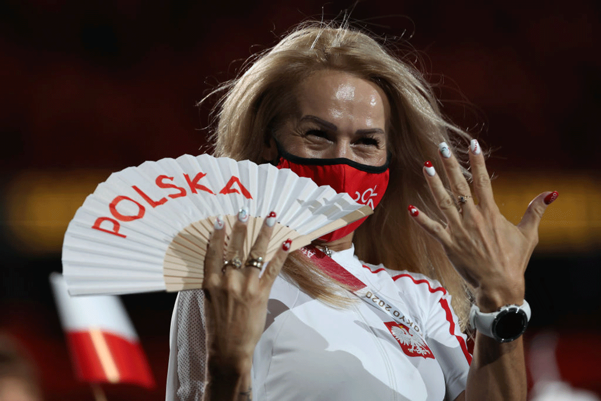 A member of Team Poland shows her fingernails painted in national colours