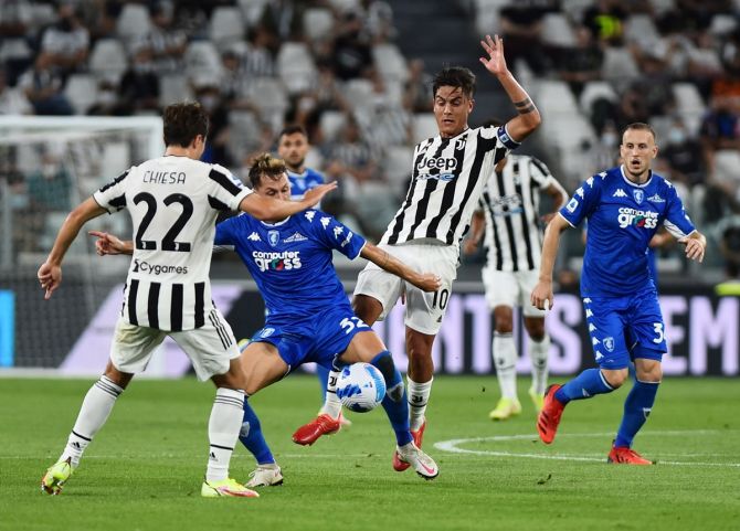 Juventus' Paulo Dybala and Federico Chiesa battle for possession with Empoli's Nicolas Haas during  Saturday's Serie A match, at Allianz stadium, in Turin, Italy.