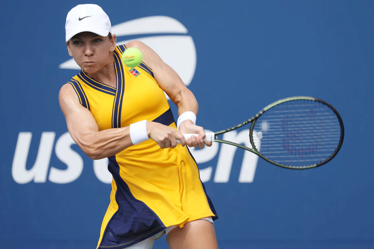 Romania's Simona Halep returns a shot against Italy's Camila Giorgi during their women's singles first round match on Day One of the 2021 US Open at the Billie Jean King National Tennis Center at Flushing Meadows in New York City on Monday