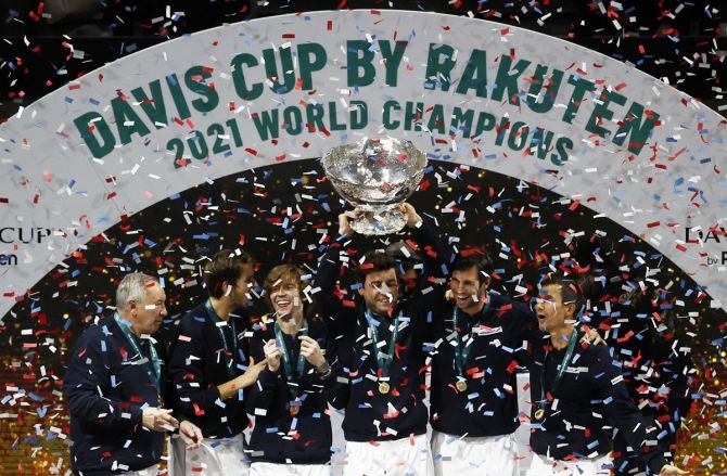 The Russian Tennis Federation team celebrates with the trophy on the podium after winning the Davis Cup at Madrid Arena, Madrid, in Spain, on Sunday.