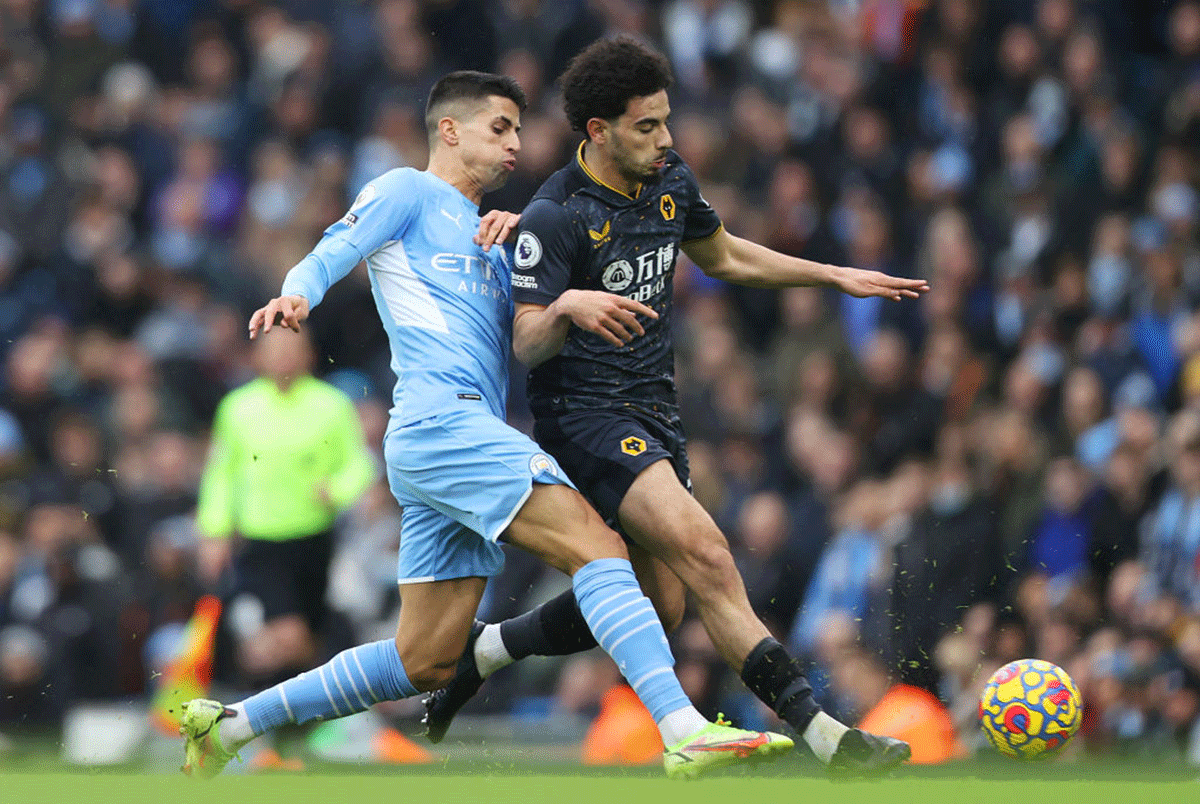 Manchester City's Joao Cancelo battles for possession with Wolverhampton Wanderers' Rayan Ait-Nouri