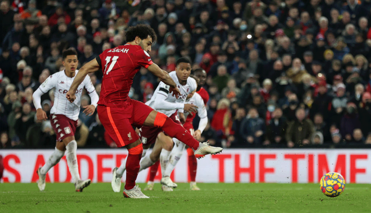 Liverpool's Mohamed Salah scores their side's first goal from the penalty spot during the match against Aston Villa at Anfield