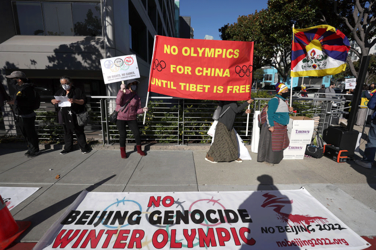 Protesters hold signs during a demonstration outside of the NBC Sports office in San Francisco, California, on Friday. Dozens of Tibetan and human rights activists staged a protest outside of the NBC Sports office to demand that the network not broadcast the 2022 Winter Olympic Games from Beijing, China due to the country's human rights abuses. 