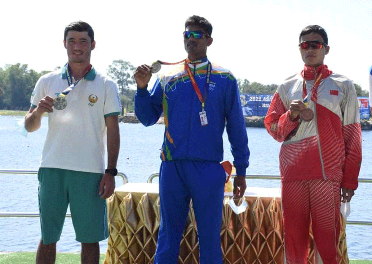 India's Arvind Singh with his gold medal on the podium after winning the lightweight men's single sculls event at the Asian Rowing Championship in Ban Chang on Sunday