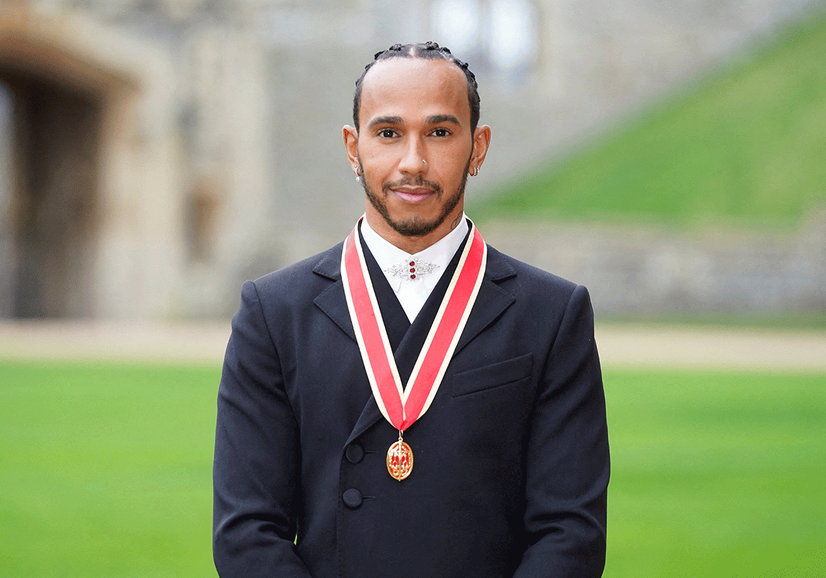 Lewis Hamilton poses for a photo after he was made a Knight Bachelor by Britain's Charles, Prince of Wales, during an investiture ceremony at Windsor Castle in Windsor, Britain, on Wednesday