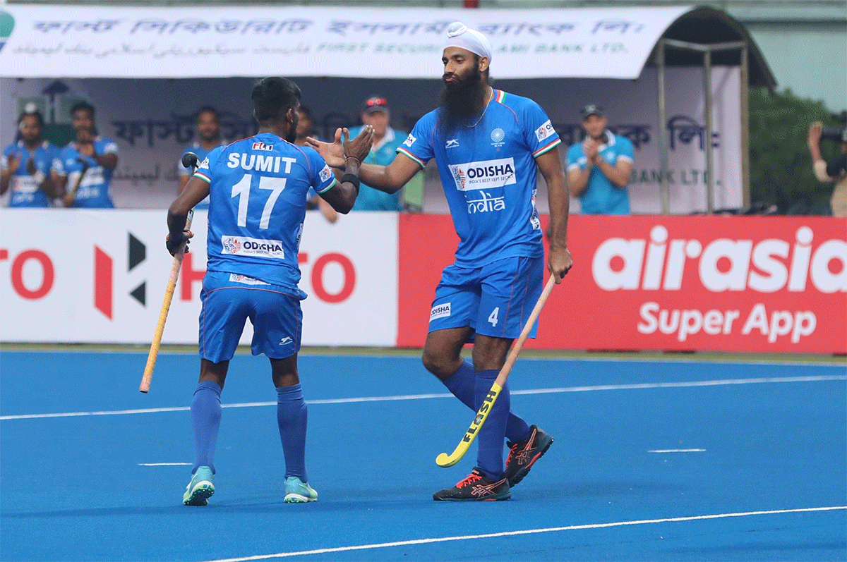 India's Jarmanpreet Singh celebrates with teammate Sumit