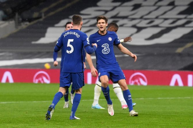 Jorginho celebrates with teammate Marcos Alonso after scoring from the penalty spot for Chelsea during the Premier League match against Tottenham Hotspur