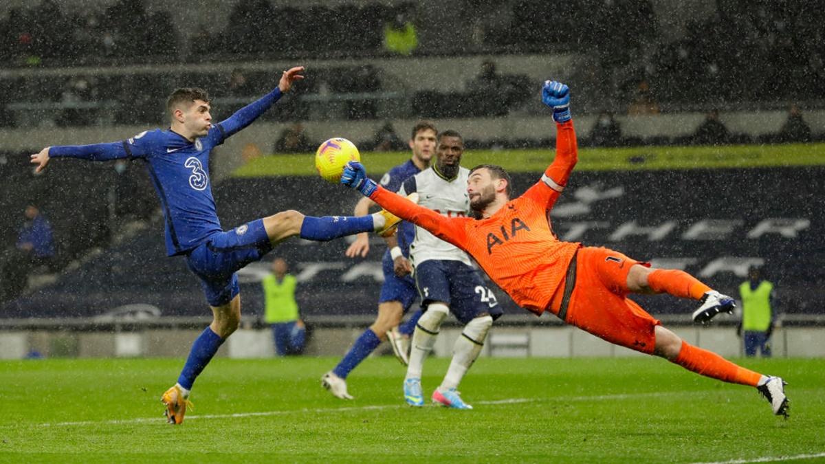 Tottenham Hotspur goalkeeper Hugo Lloris  punches the ball clear from Chelsea's Christian Pulisic.