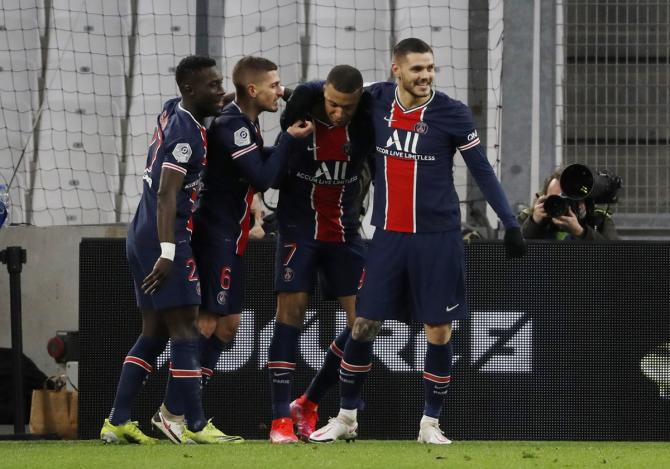 Kylian Mbappe celebrates with teammates after scoring Paris St Germain's first goal with teammates in Sunday's Ligue 1 match against Olympique de Marseille.