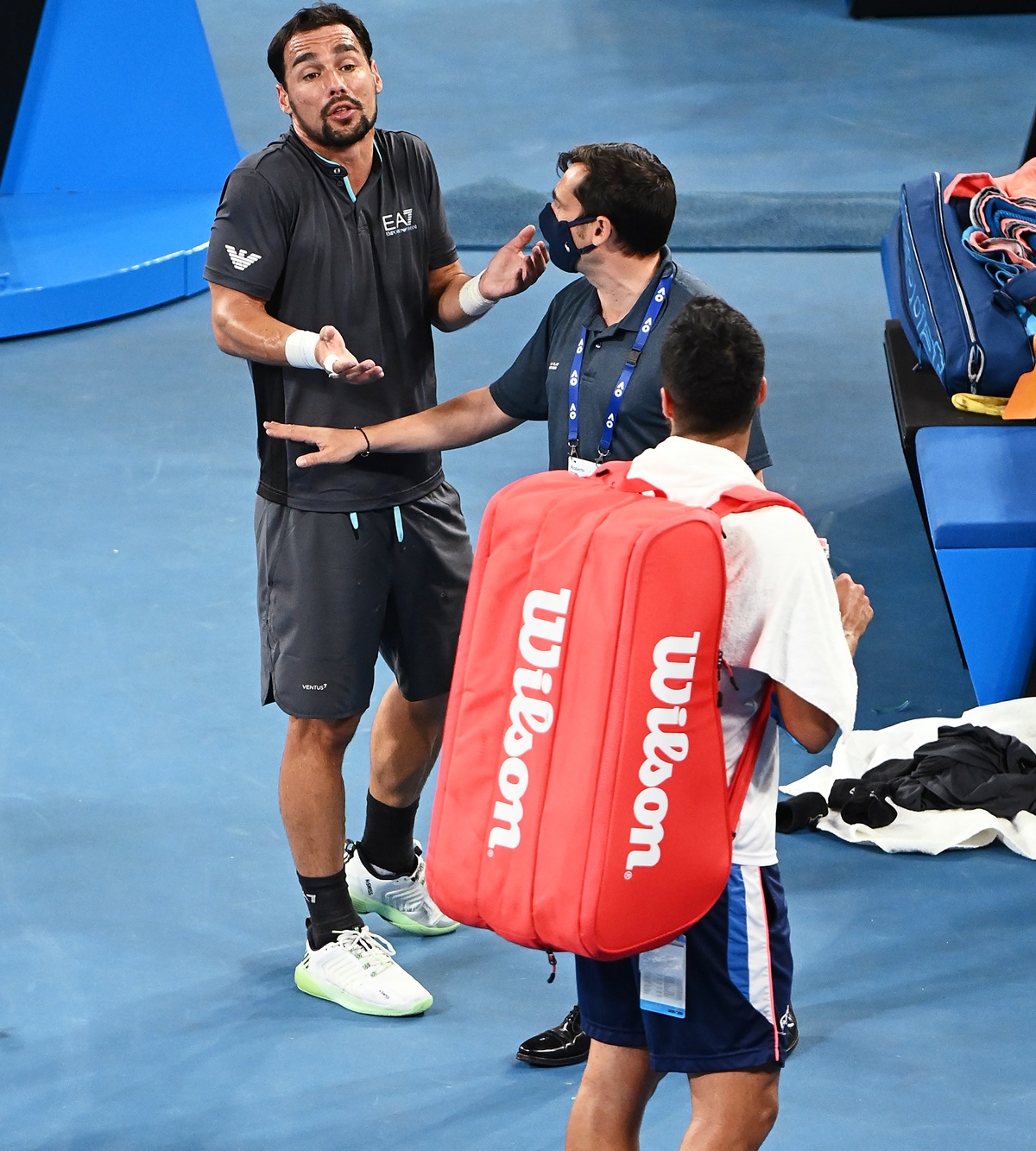 A tournament official intervenes as Fabio Fognini and Salvatore Caruso get into a heated argument.