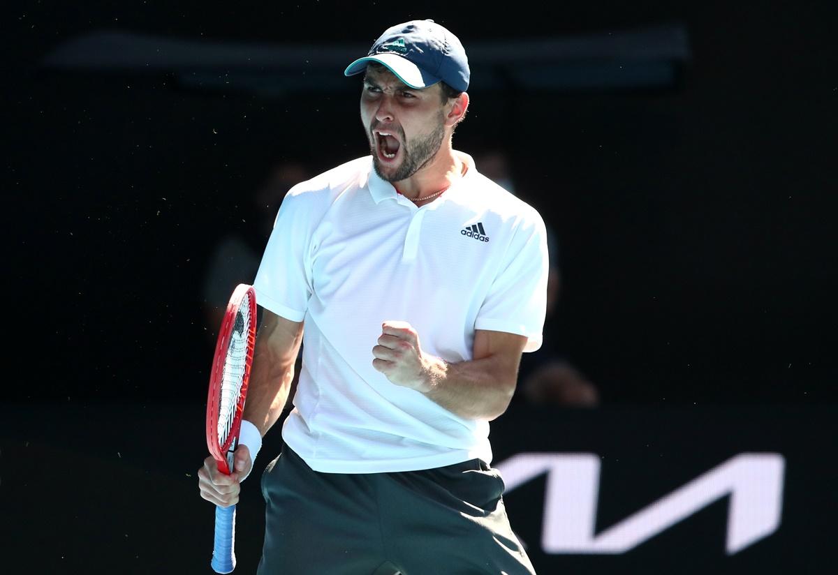 Russia's Aslan Karatsev celebrates winning his fourth round match against Canada's Felix Auger Aliassime.