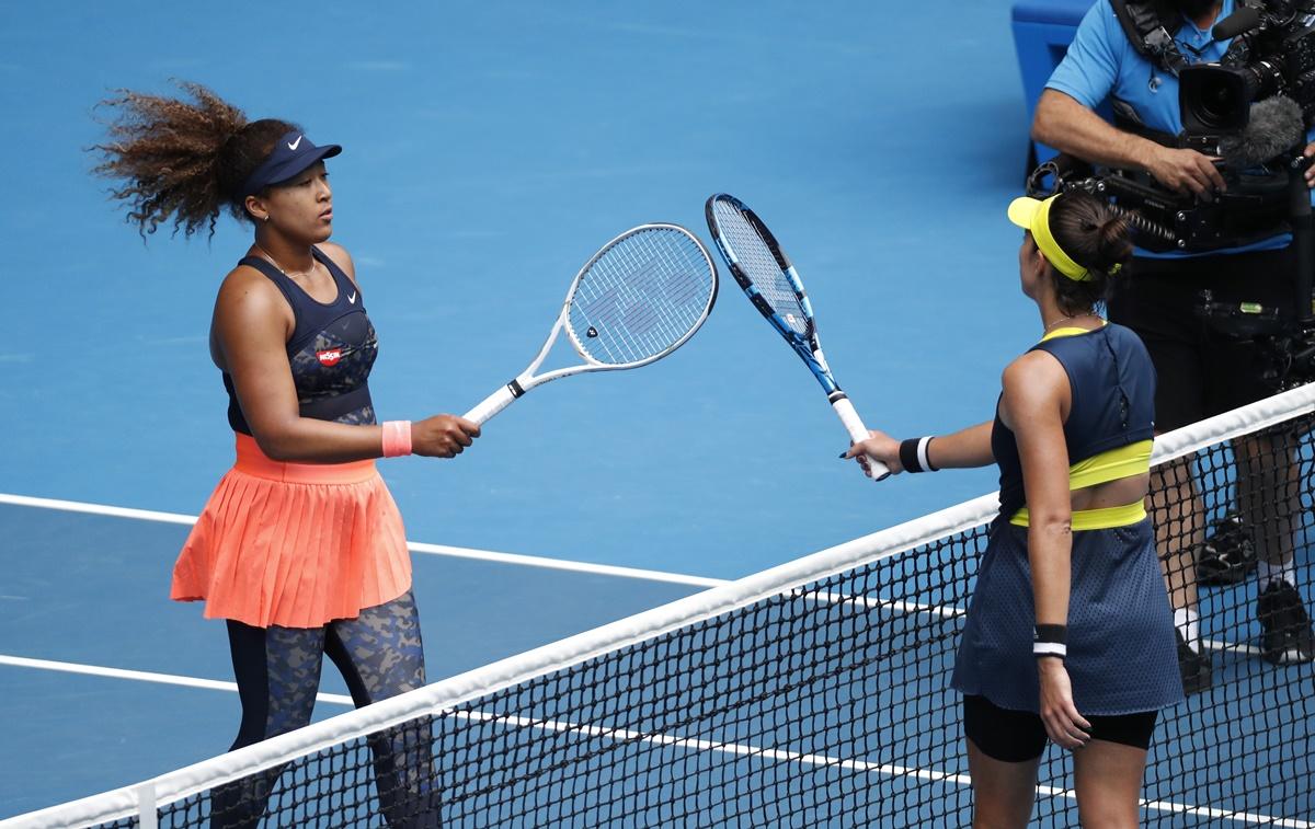 Naomi Osaka and Garbine Muguruza meet at the net after their fourth round match. 