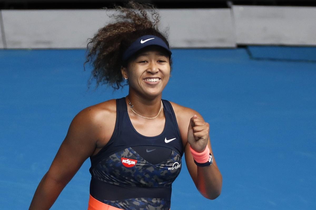 Japan's Naomi Osaka celebrates winning her fourth round match against Spain's Garbine Muguruza at the Australian Open on Sunday