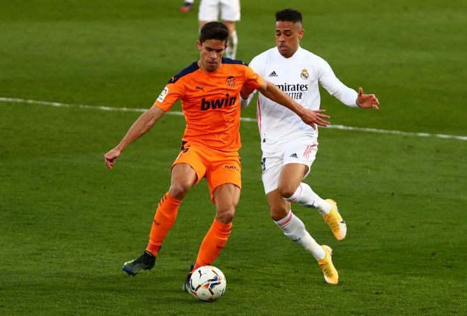 Real Madrid's Mariano Diaz in action with Valencia's Gabriel Paulista