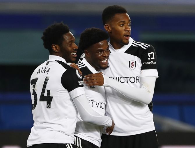 Josh Maja celebrates scoring  Fulham's second goal with Ola Aina and Tosin Adarabioyo against Everton.