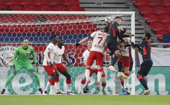 Liverpool's Roberto Firmino and RB Leipzig's Marcel Sabitzer vie for an aerial ball 