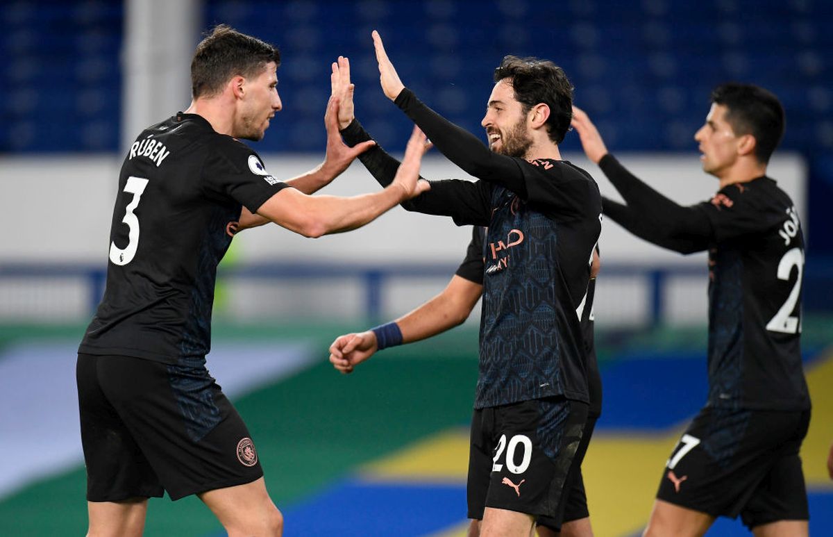 Manchester City's Bernardo Silva celebrates with teammate Ruben Dias (left) after scoring against Everton during their Premier League match at Goodison Park in Liverpool