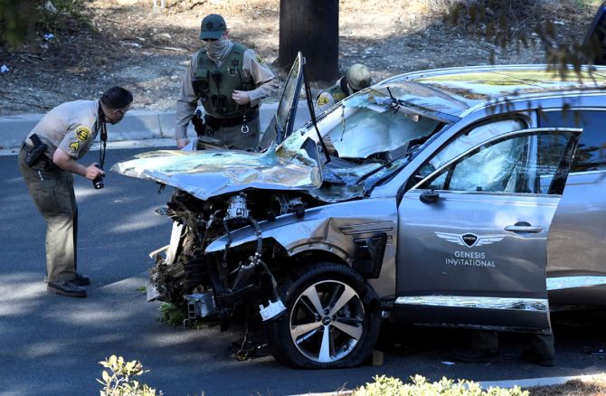  Los Angeles County Sheriff's deputies inspect the vehicle of golfer Tiger Woods, who suffered multiple injuries in a serious car accident in Los Angeles in February. 