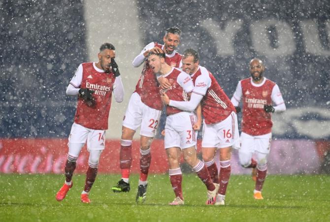 Arsenal's Kieran Tierney celebrates with teammates on scoring their first goal against West Bromwich Albion at The Hawthorns, West Bromwich, on Saturday 