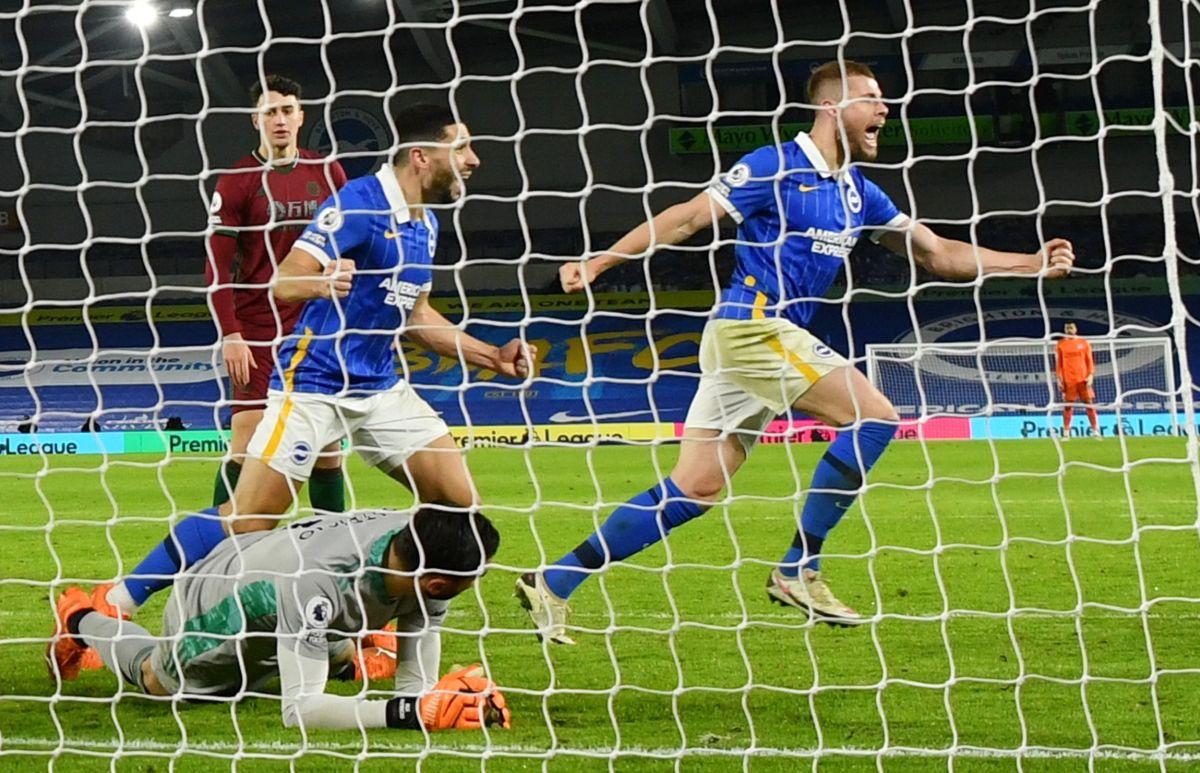 Brighton & Hove Albion's Adam Webster and Neal Maupay celebrate after Lewis Dunk scores the equalising third goal against Wolverhampton Wanderers at The American Express Community Stadium, Brighton