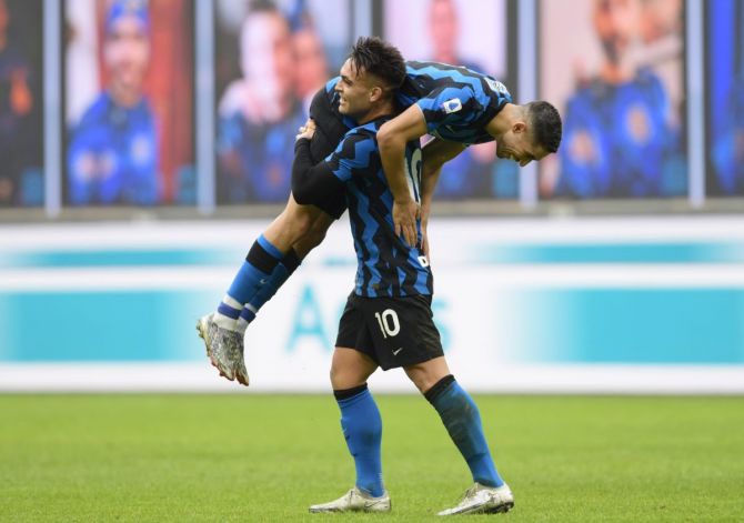 Inter Milan's Achraf Hakimi celebrates scoring their sixth goal with Lautaro Martinez during their Serie A match against Crotone at San Siro in Milan on Sunday 